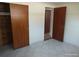 Bedroom featuring tile flooring, closet, and doorway leading to adjacent room at 12716 Mulberry Ln, Hudson, FL 34667