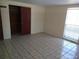 Bedroom with tile floors, neutral walls, closet and large window, offering a comfortable and functional space at 12716 Mulberry Ln, Hudson, FL 34667
