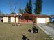 Charming single-story home with a well-maintained front yard and mature trees on a sunny day at 12716 Mulberry Ln, Hudson, FL 34667