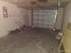 View of the garage featuring a garage door and some stored items at 12716 Mulberry Ln, Hudson, FL 34667
