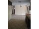 Kitchen with tile floors, light walls, dark cabinets and access to other rooms in an open-concept layout at 12716 Mulberry Ln, Hudson, FL 34667