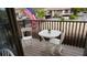 Outdoor seating on the balcony with black rails and an American flag at 12816 Wedgewood Way # D, Hudson, FL 34667