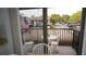 View from inside out to a small balcony featuring a table, chairs and flag at 12816 Wedgewood Way # D, Hudson, FL 34667