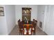 Formal dining room with wood table, seating for eight, and a traditional chandelier and cabinet at 12816 Wedgewood Way # D, Hudson, FL 34667