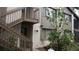 Exterior view of condo complex with stairway leading to second level at 12816 Wedgewood Way # D, Hudson, FL 34667