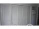 White closets along the hall featuring louvered doors and white trim at 12816 Wedgewood Way # D, Hudson, FL 34667