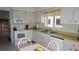 Bright kitchen with white cabinets, appliances and natural light at 12816 Wedgewood Way # D, Hudson, FL 34667