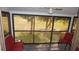 Screened lanai with golf course views, ceiling fan, and comfortable seating at 12816 Wedgewood Way # D, Hudson, FL 34667