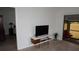 A television and plant decorate the modern console in the living room at 12816 Wedgewood Way # D, Hudson, FL 34667