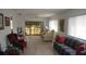 Comfortable living room with tile flooring and sliders that lead to a screened porch at 12816 Wedgewood Way # D, Hudson, FL 34667
