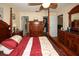 Another angle of the main bedroom showcasing wood floors, closet, and en suite bathroom at 13009 Wedgewood Way # C, Hudson, FL 34667