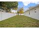 Large backyard featuring green grass and a white fence at 13186 Road Runner Ave, Weeki Wachee, FL 34614