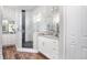 Bright, modern bathroom with granite vanity, double sinks, and a luxurious walk-in shower at 13186 Road Runner Ave, Weeki Wachee, FL 34614