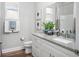 Modern bathroom features granite countertops, hardwood floors, and double sinks at 13186 Road Runner Ave, Weeki Wachee, FL 34614