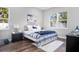 Bright bedroom features hardwood floors, stylish décor, and plenty of natural light at 13186 Road Runner Ave, Weeki Wachee, FL 34614