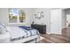 Bedroom boasts hardwood floors, natural light, and a dark wood dresser at 13186 Road Runner Ave, Weeki Wachee, FL 34614