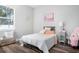 Bright bedroom with stylish decor, a cozy bed, and a large window offering natural light at 13186 Road Runner Ave, Weeki Wachee, FL 34614