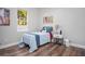 Cozy bedroom features hardwood floors, natural light, and surfboard-themed decor at 13186 Road Runner Ave, Weeki Wachee, FL 34614