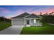 Charming single-story home with a well-manicured lawn and a two-car garage showcasing curb appeal at 13186 Road Runner Ave, Weeki Wachee, FL 34614