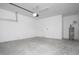 Clean and bright two-car garage featuring white walls and concrete flooring at 13186 Road Runner Ave, Weeki Wachee, FL 34614