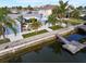 Aerial view of a backyard featuring pool, shed, dock, and waterway access for waterfront living at 13604 Maria Dr, Hudson, FL 34667