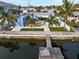 Waterfront backyard featuring a dock, pool, shed, and well-maintained landscaping for relaxation and enjoyment at 13604 Maria Dr, Hudson, FL 34667