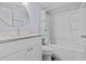 Bathroom features a shower and tub combo and white vanity with granite countertop at 13604 Maria Dr, Hudson, FL 34667