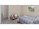 Bedroom includes wood floors, a window, and a television at 13604 Maria Dr, Hudson, FL 34667