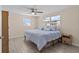 Bedroom with a ceiling fan, wood-look flooring, and two windows to let in the natural light at 13604 Maria Dr, Hudson, FL 34667