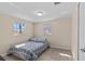 Cozy bedroom with hardwood floors and two sunny windows at 13604 Maria Dr, Hudson, FL 34667