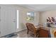 Bright entryway features a wood-look floor, comfortable seating, and a clear view to the front yard at 13604 Maria Dr, Hudson, FL 34667