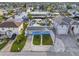 Exterior view showcasing waterfront home with a manicured lawn, dock, and canal access in coastal community at 13604 Maria Dr, Hudson, FL 34667