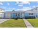 Charming, light blue single-Gathering home with well-manicured lawn and inviting walkway to the front door at 13604 Maria Dr, Hudson, FL 34667