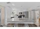 Bright modern kitchen with a peninsula counter, stainless appliances and wood-look flooring at 13604 Maria Dr, Hudson, FL 34667