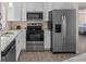 Kitchen with stainless steel appliances, updated countertops and cabinets, and wood flooring at 13604 Maria Dr, Hudson, FL 34667