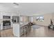 Open floorplan with kitchen island seating, furniture, wood floors and stainless steel appliances at 13604 Maria Dr, Hudson, FL 34667