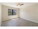 A brightly lit bedroom area with tile flooring, a ceiling fan, and a window at 14001 Gulf Blvd # 310, Madeira Beach, FL 33708