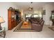 Inviting living room featuring tile floors, media center, and comfortable seating area at 14148 Finsbury Dr, Spring Hill, FL 34609