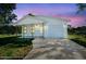 Charming one-story white home with a covered porch and an attached one-car garage at 14356 Earline Rd, Brooksville, FL 34614