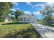 Inviting exterior of a modern white house with a well-manicured lawn and a paved driveway at 14356 Earline Rd, Brooksville, FL 34614
