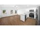 Open kitchen and living room with stainless steel appliances and natural light at 14356 Earline Rd, Brooksville, FL 34614
