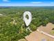 Aerial view highlighting a large property nestled among lush trees and open landscapes at 16284 Sandusky St, Brooksville, FL 34604