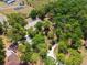 A lush, tree-filled property location featuring a home with outbuildings and a long driveway at 16284 Sandusky St, Brooksville, FL 34604