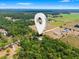 Aerial view of the property location surrounded by lush, green forest and open fields at 16284 Sandusky St, Brooksville, FL 34604