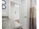 Bathroom with granite counters, a sink, and a view into another room at 16284 Sandusky St, Brooksville, FL 34604
