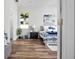 Bright bedroom featuring wood-look floors, white walls, and a comfortable bed with blue accents at 16284 Sandusky St, Brooksville, FL 34604