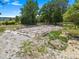 Property construction site displaying a home's foundation amidst dirt and greenery at 16284 Sandusky St, Brooksville, FL 34604