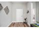 Bright entryway featuring wood-look flooring, a white door, and tasteful decor at 16284 Sandusky St, Brooksville, FL 34604