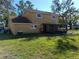 Backyard view of home with a screened-in patio at 1995 59Th S Cir, St Petersburg, FL 33712