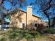 Side exterior view of a home featuring a chimney and well-maintained landscaping at 1995 59Th S Cir, St Petersburg, FL 33712